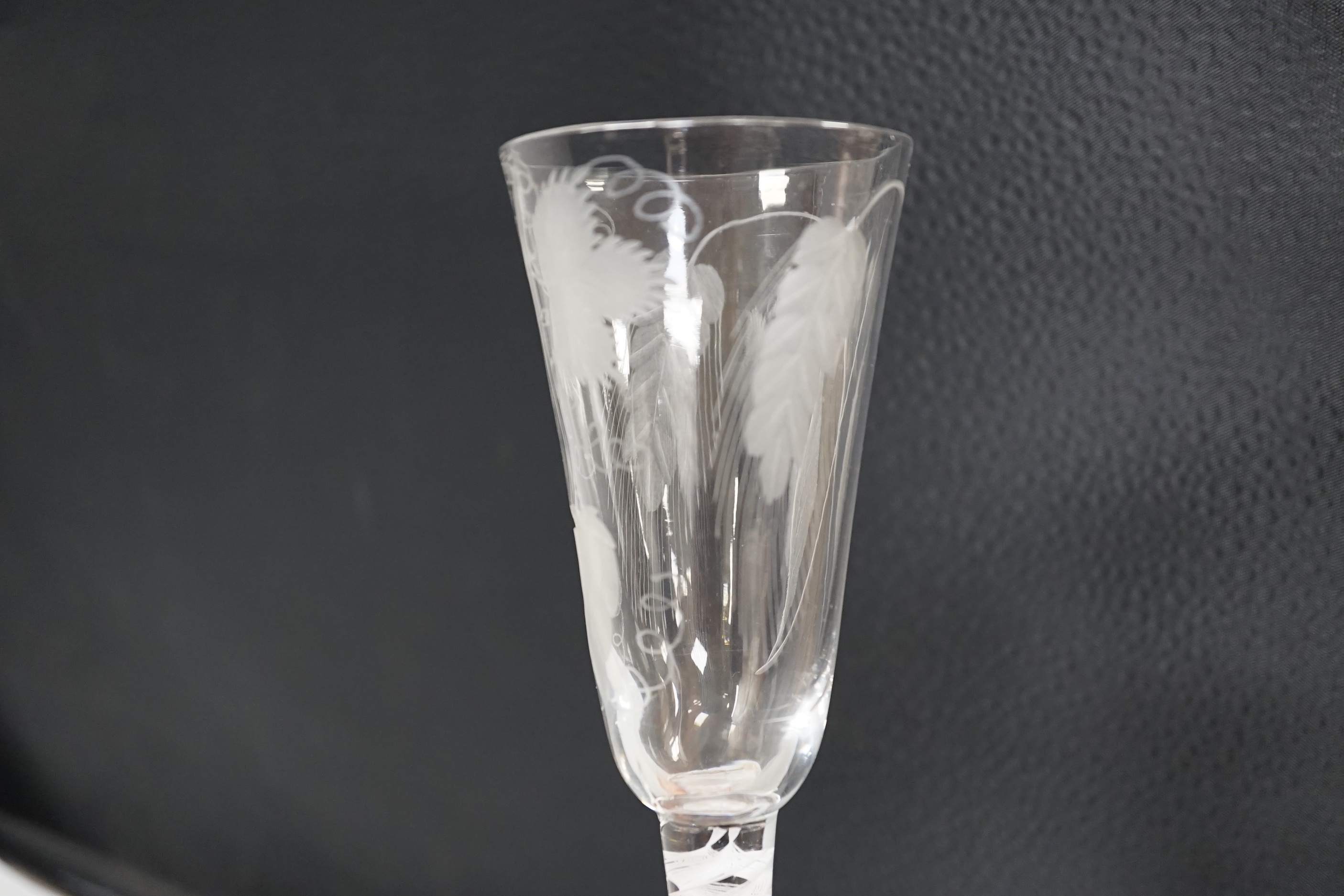 An English lead crystal SSOT ale glass, c.1760, the elongated round funnel bowl engraved with hops and barley, the stem with a rare SSOT scrambled eighteen ply spiral band, conical foot, snapped pontil, tool marked and s